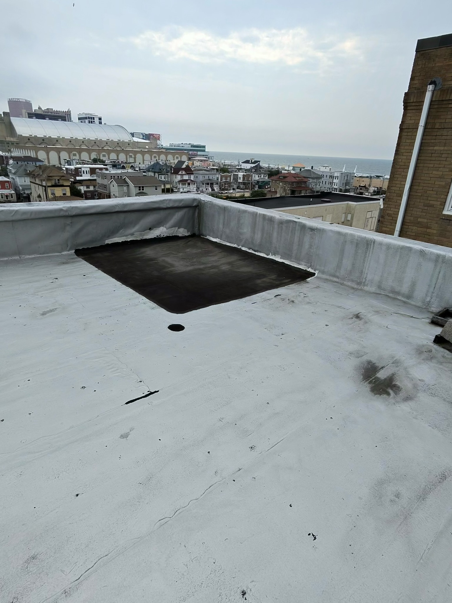 Twin Shield Roofing crew completing a roof repair overlooking South Jersey
