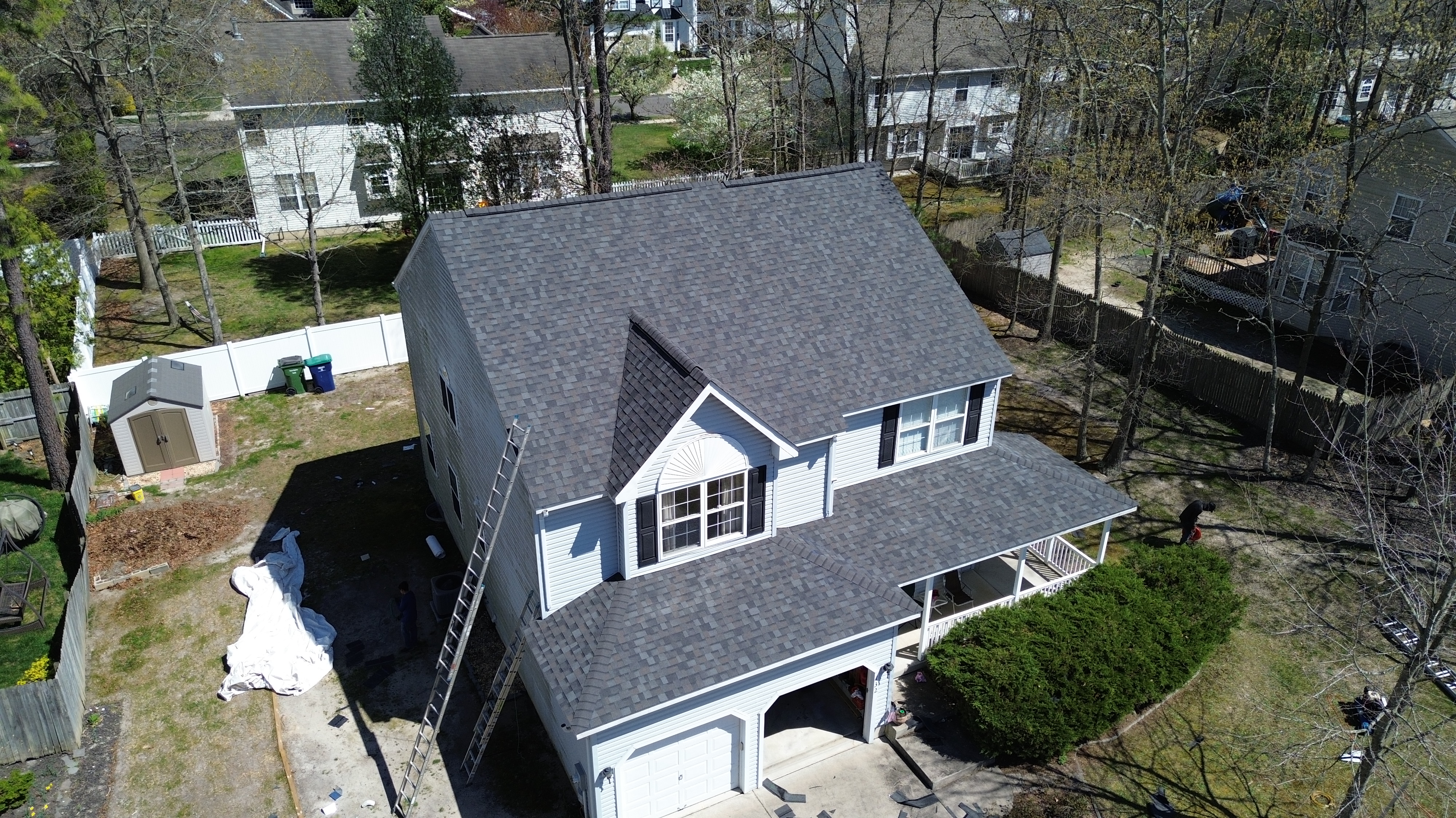 Roofers installing high-performance shingles on residential home