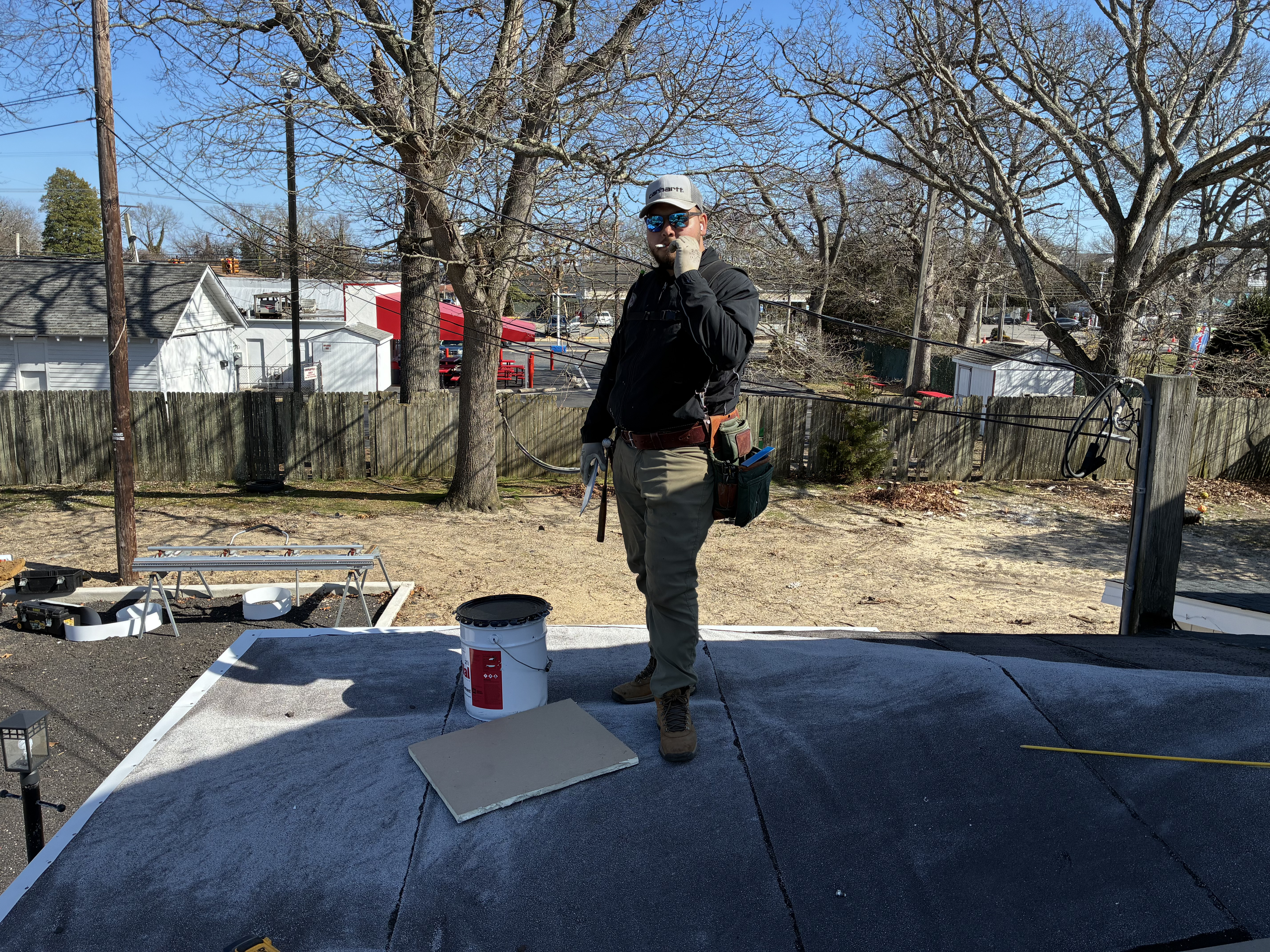 Roofer installing shingles on a South Jersey home