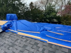 Roofing crew performing storm damage repairs on an Atlantic County home
