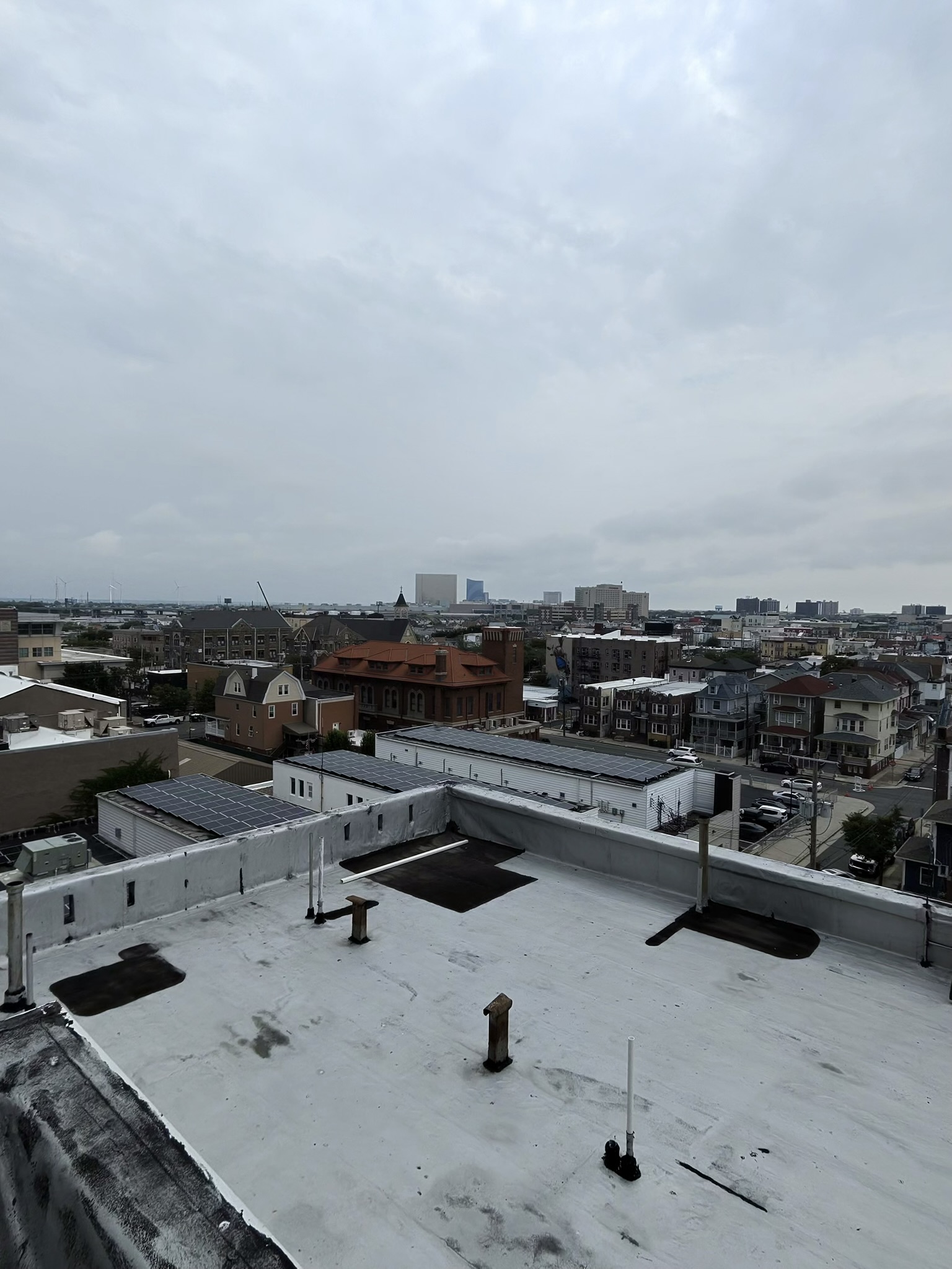 Commercial flat rooftop with outdoor seating on a city building