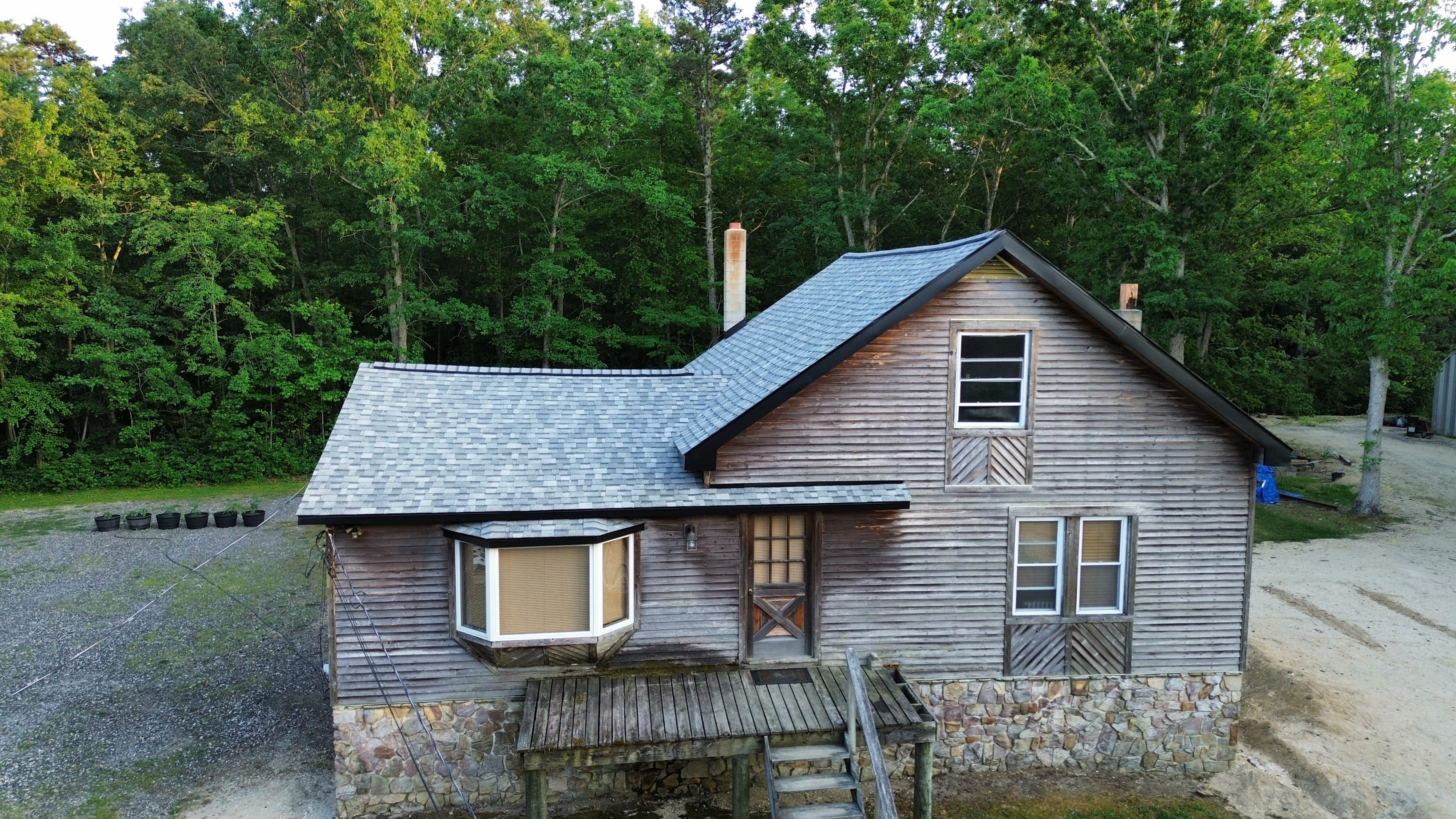 Roofer with hammer completing residential installation