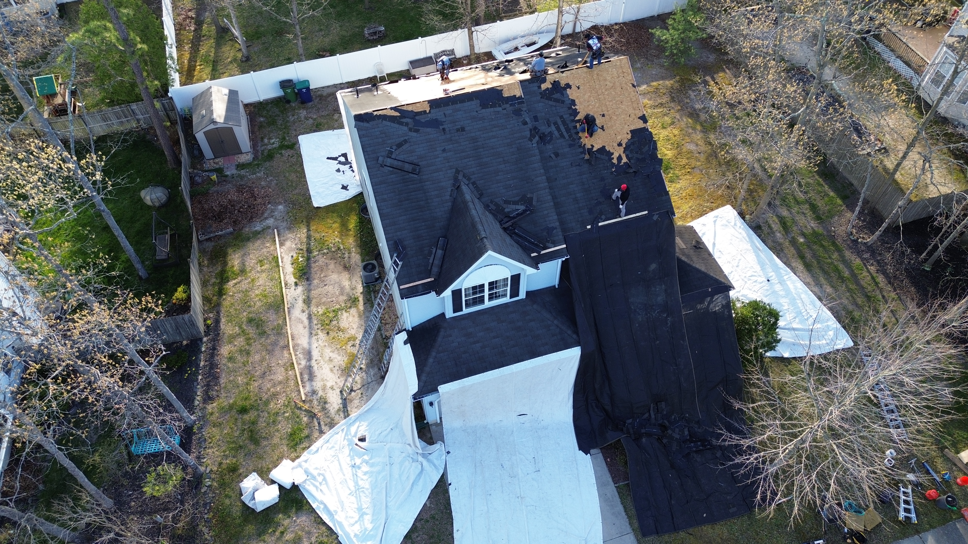 Roofer replacing shingles on a residential home